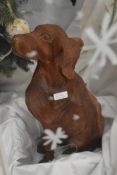 A Black Forest style carved seated hound, H55cm, sold together with another dog carved from teak