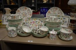 A Minton Bone China tea / dessert service, decorated with multicoloured foliage on a white ground,