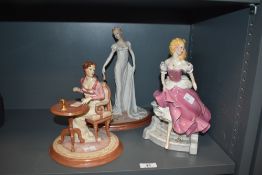 A group of three female figures, to include Cinderella by Franklin Mint, h26cm, a Jane Austen's Emma