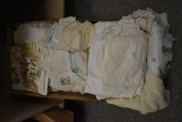 A boxed selection of mixed fabrics and doilies etc.