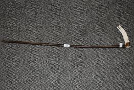 A late 19th / early 20th century walking stick, the antler handle intricately hand carved