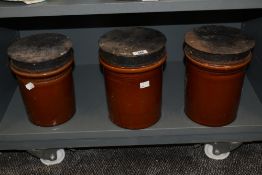 Three vintage brown glazed kitchen storage jars metal covers, 24cm overall, rusting to covers.