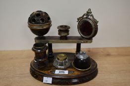 An unusual Victorian grained/simulated wood desk top stand, of oval form with six 'divisions'