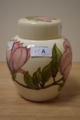 A Moorcroft pottery ginger jar, decorated having hand painted pink and green foliage on a magnolia