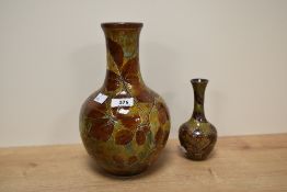An early 20th century Royal Doulton stoneware baluster vase, having leaf decoration on a glazed