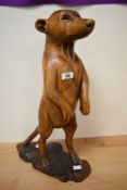 A large carved wooden Meerkat figure, modelled standing on alert, 50cm high