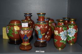 A group of oriental enamel Cloisonne ware, to include miniature baluster vases on wooden stands,