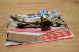 A 19th century brass and mahogany pocket microscope, with turned handle and screw-off 'cover'
