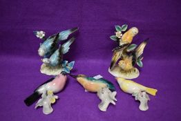 A group of five mid-century pottery bird ornaments, three being wall mounted