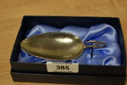 A reproduction duck handled child's feeding spoon, having hammered textured pattern and in the