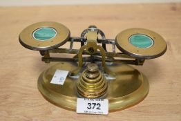 A set of late 19th/early 20th century malachite inset brass postal scales, together with