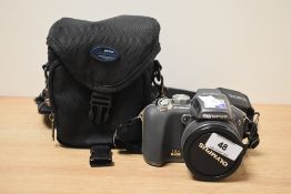 An Olympus SP-55OUZ camera with digital Quanytaray case.