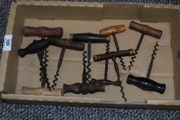 A box containing various 19th century hand pull corkscrew bottle openers, L13cm.