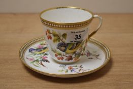 A vintage Royal Worcester porcelain tea cup and saucer, beautifully hand painted with birds, gilding