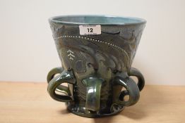 An early 20th century C.H.Brannam Barnstable style drinking vessel, having a flared body supported