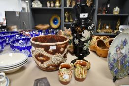 A late 19th century black opaque glass vase, decorated in the aesthetic style, having hand painted