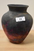A Raku fired studio pottery baluster vase, having copper fumed surface, signed to base, h17cm.