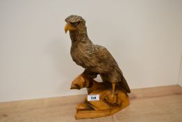 A 20th century Russian carved wood eagle study, modelled standing with wings folded, 30.5cm