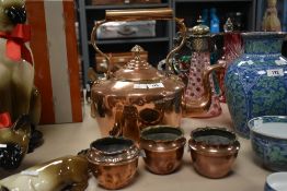 A large 19th century copper kettle sold together with three small bowls one having Art Nouveau