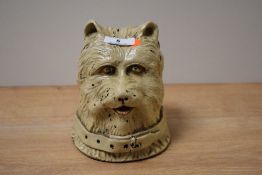 A 19th century stoneware West Highland Terrier money box, hand painted with cream glaze, h15cm.