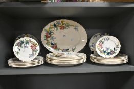 An early 20th century Burslem part dinner service, decorated with foliage on a white ground, to