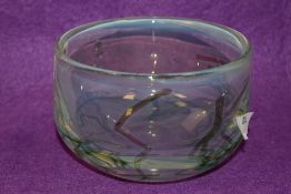 A John Ditchfield vaseline glass bowl, tinted in green and blue with a trailed design, etched and