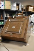 A late 19th /early 20th oak coal scuttle, having original scoop and tray, h36cm.