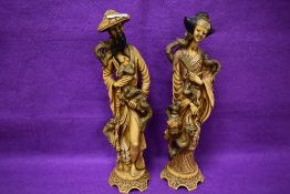 A pair of large reproduction simulated ivory figures, of Oriental design 38cm