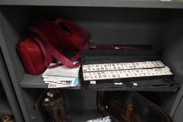 A Chinese MahJohg travel game set, to include two trays of tiles, bag, translucent cover ect