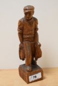 A 20th Century carved oak folk art study of a fisherman and his catch, signed 'W.Lang' to the rear