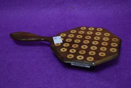 An early 20th century inlaid mahogany solitaire board with integral handle and turned bone markers