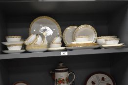 A fine bone China part tea / dinner service, having gilt flared edging and foliage motif patterns on
