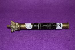 A 19th century brass and turned ebony police tipstaff, of traditional form with screw-off crown