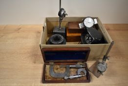 A box containing various measuring instruments, to include an airguide dash mounted compass, a cased