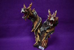 A striking hand-carved and painted wood double dragon head sculpture 30cm