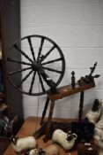 A 19th century oak spinning wheel having raised elm structure, partly assembled, H89cm.