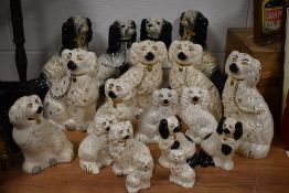 A collection of early to mid 20th century Staffordshire Spaniel's, largest H29.5cm, (18).