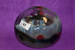 A John Ditchfield clear art glass vase, of spherical form with a trailed design featuring a band