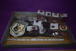 An assortment of badges and pins including Westminster Angling Society, Townswomen 1929-1979 and