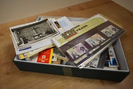 A box full of postcards and stamps, to include various Christmas post cards, diversity postcards,
