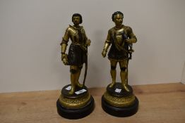 A pair of cast and gilt painted metal knight figures, each on cast moulded base and turned wooden