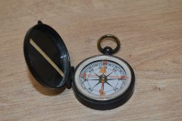 A 20th century pocket compass, of hinged circular form with suspension ring 5cm diameter
