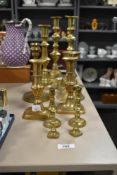 A group of late 19th / early 20th century brass candle sticks, tallest measuring 28cm.