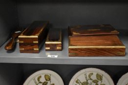 A group of four modern brass mounted desk top hardwood boxes, one with secret drawer and sold