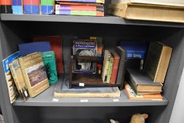 An early 20th century oak book trough stand, L29.5cm, sold together with a selection of books, to