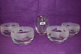 Four decorative boxed crystal glass bowls all etched with scenes depicting hares, sold together with