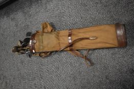 A vintage golf bag containing golf clubs, to include wedges, hickery shafted clubs and putters ect
