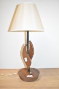 A mid-century teak table top/bedside lamp with shade, H45cm.
