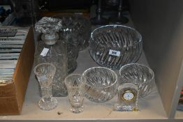A selection of cut glass items comprising decanter, mantel clock and bowls of various sizes etc.
