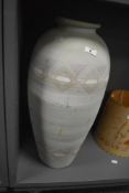A large mid-century teracotta baluster vase, having Aztec patterns on an egg shell ground, h59cm.